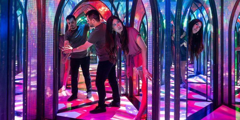 couple navigating mirror maze