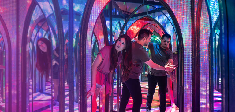 couple navigating mirror maze